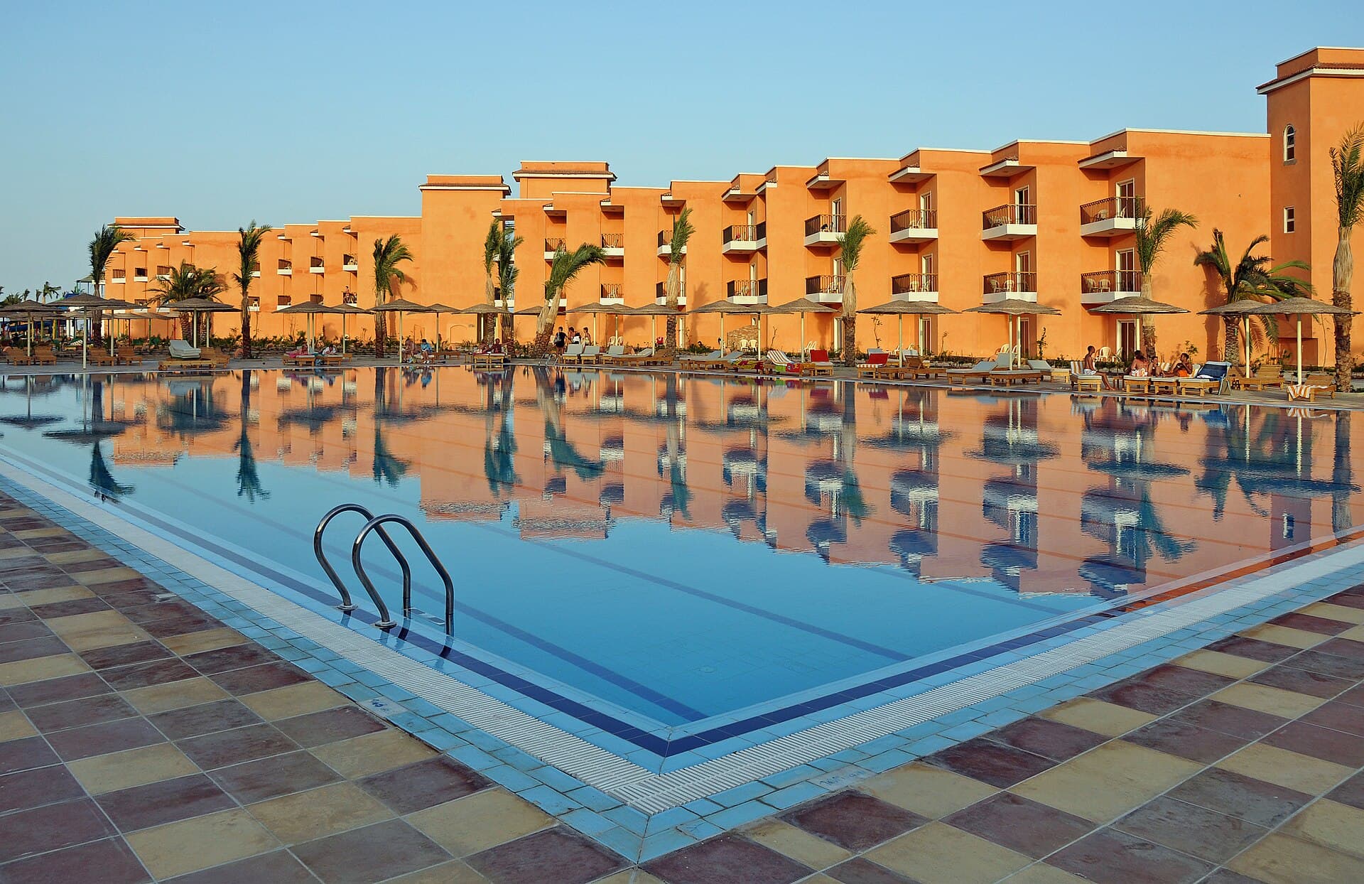 O piscină exterioară mare, într-un complex hotelier, cu culoare de înot și clădiri portocalii în fundal. (Foto de arhivă: Marc Ryckaert ( MJJR ) / CC BY 3.0, Wikimedia Commons)